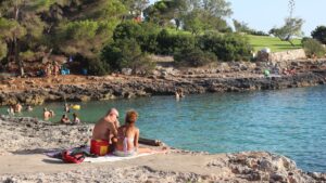 Family enjoying holidays on a sunny beach in Spain